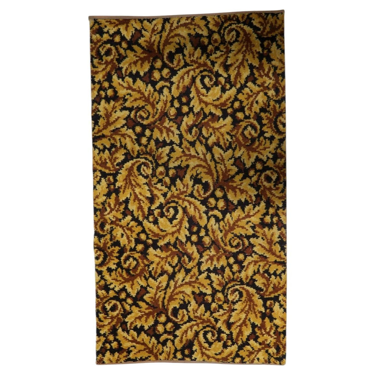 Vintage 1960s German acrylic area rug featuring rich gold and deep brown foliate scrollwork across a dense woven pile.