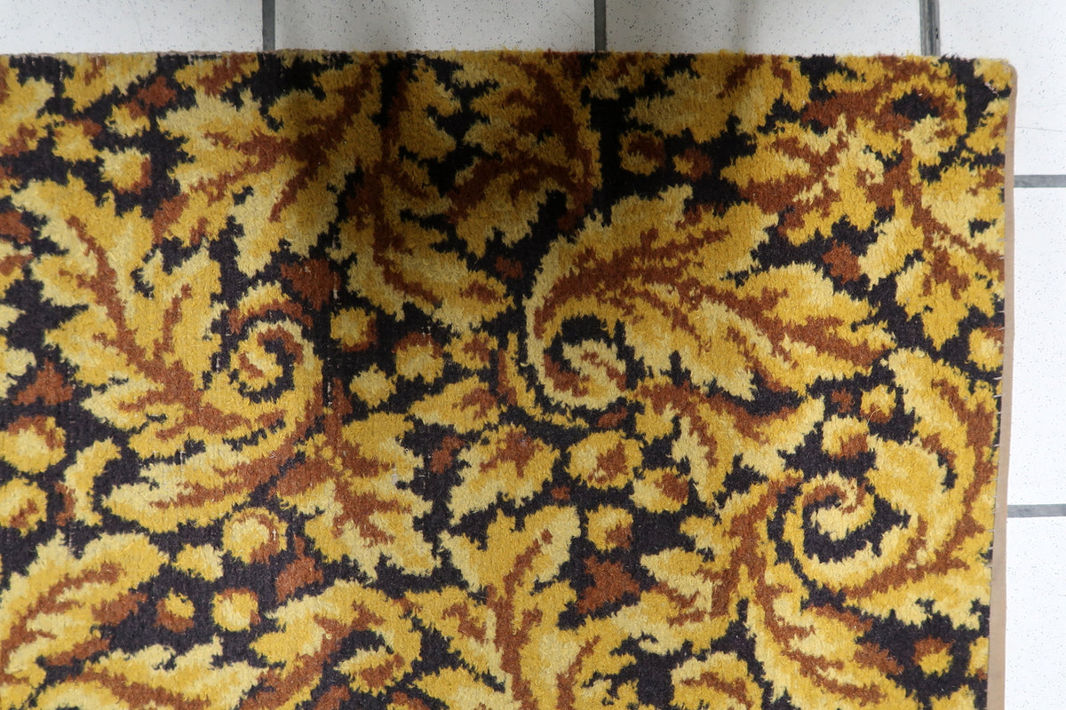 Mid-century modern West German carpet woven with warm honey gold and earth-toned brown acanthus scroll motifs.
