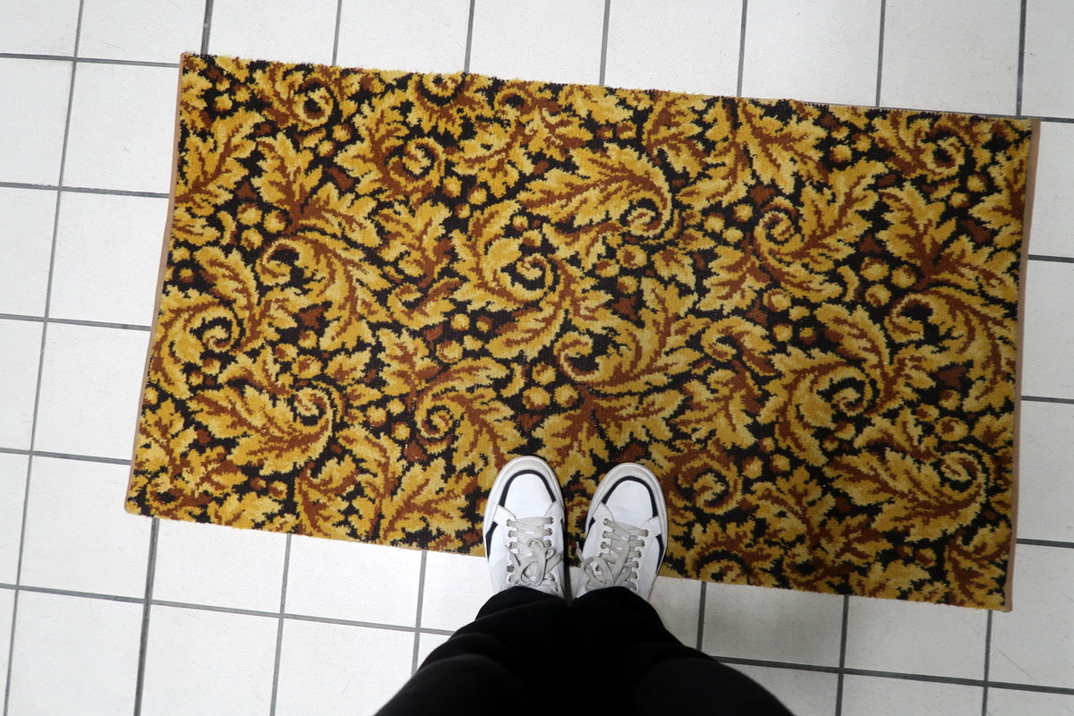 Detailed leaf scrolls, organic arabesques, and botanical flourishes woven into a vintage 1960s German living room rug.
