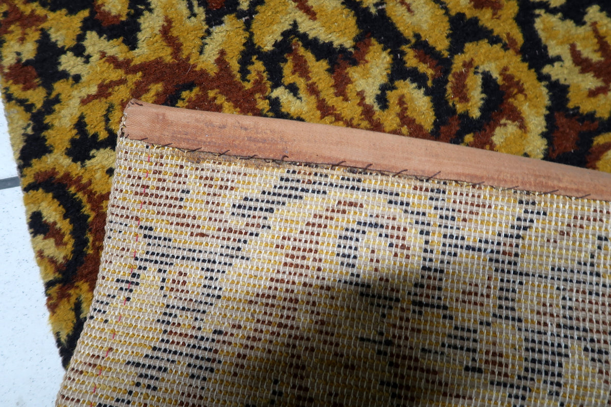 Low-maintenance colorfast acrylic fiber weave construction on a 1960s West German vintage accent rug.