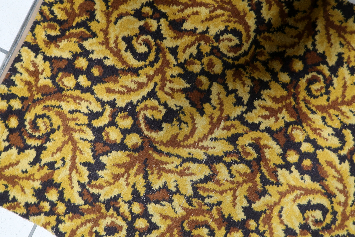 Mid-century modern West German carpet woven with warm honey gold and earth-toned brown acanthus scroll motifs.