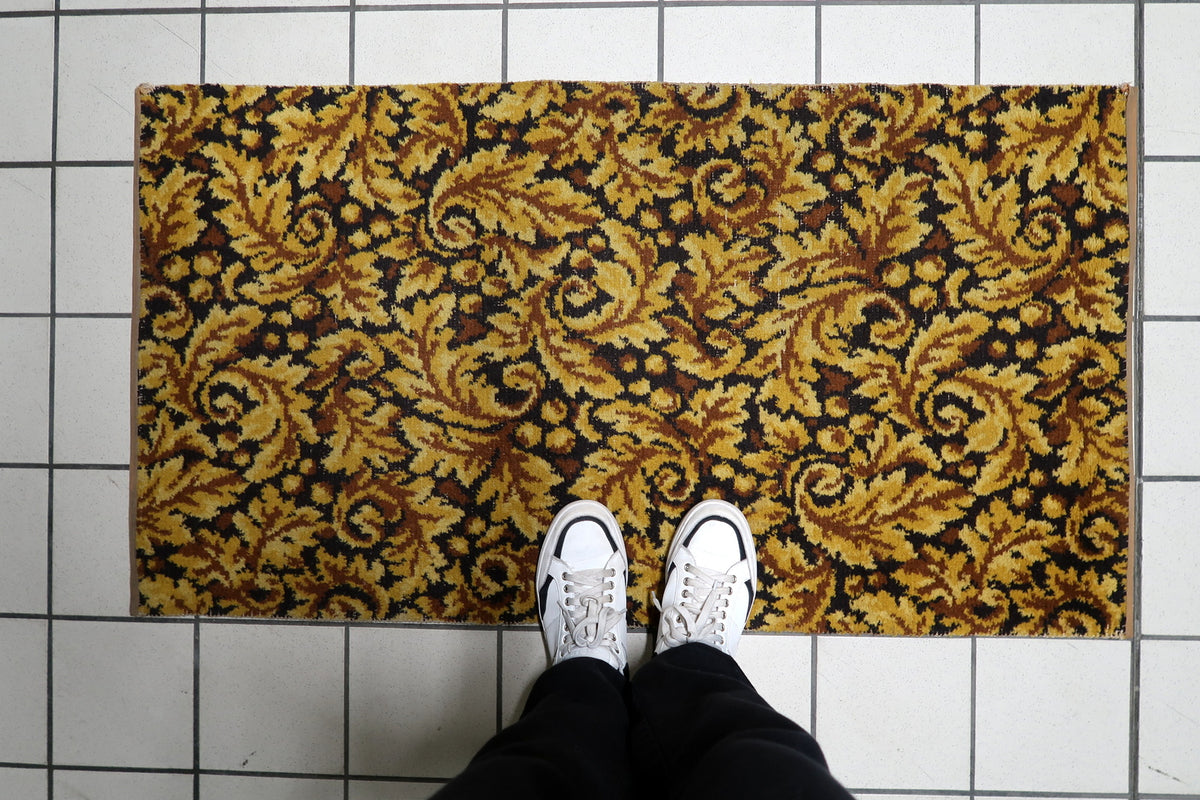 Detailed leaf scrolls, organic arabesques, and botanical flourishes woven into a vintage 1960s German living room rug.