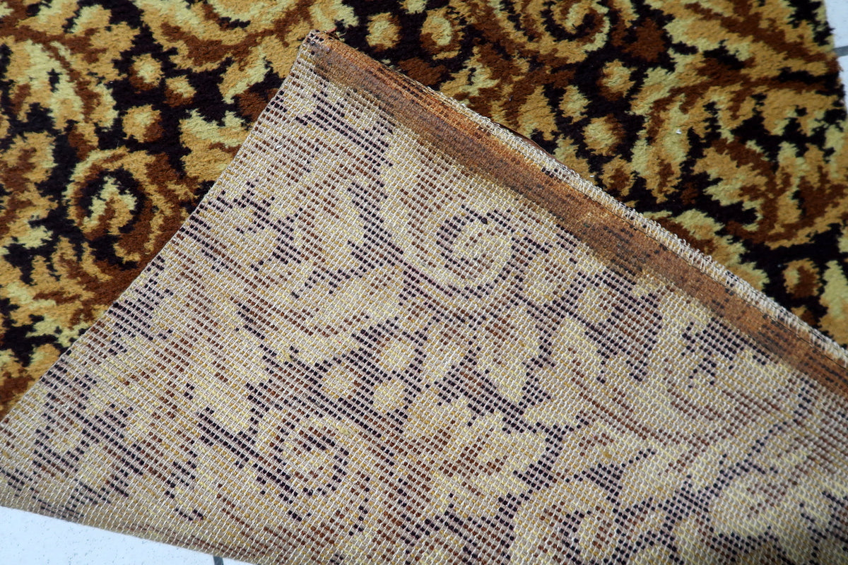 Vintage gold and brown runner rug designed with elegant foliate elements and traditional styling