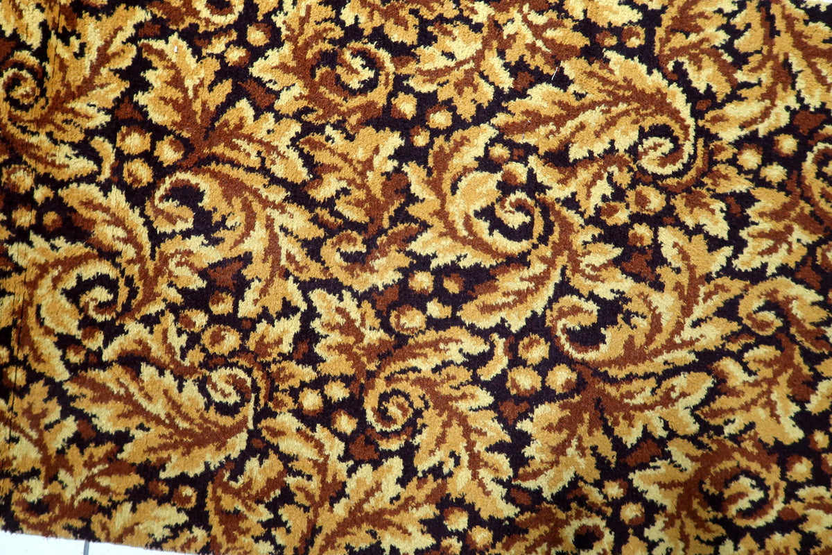 Vintage German runner carpet in warm gold and brown tones featuring an elegant scrolling leaf motif