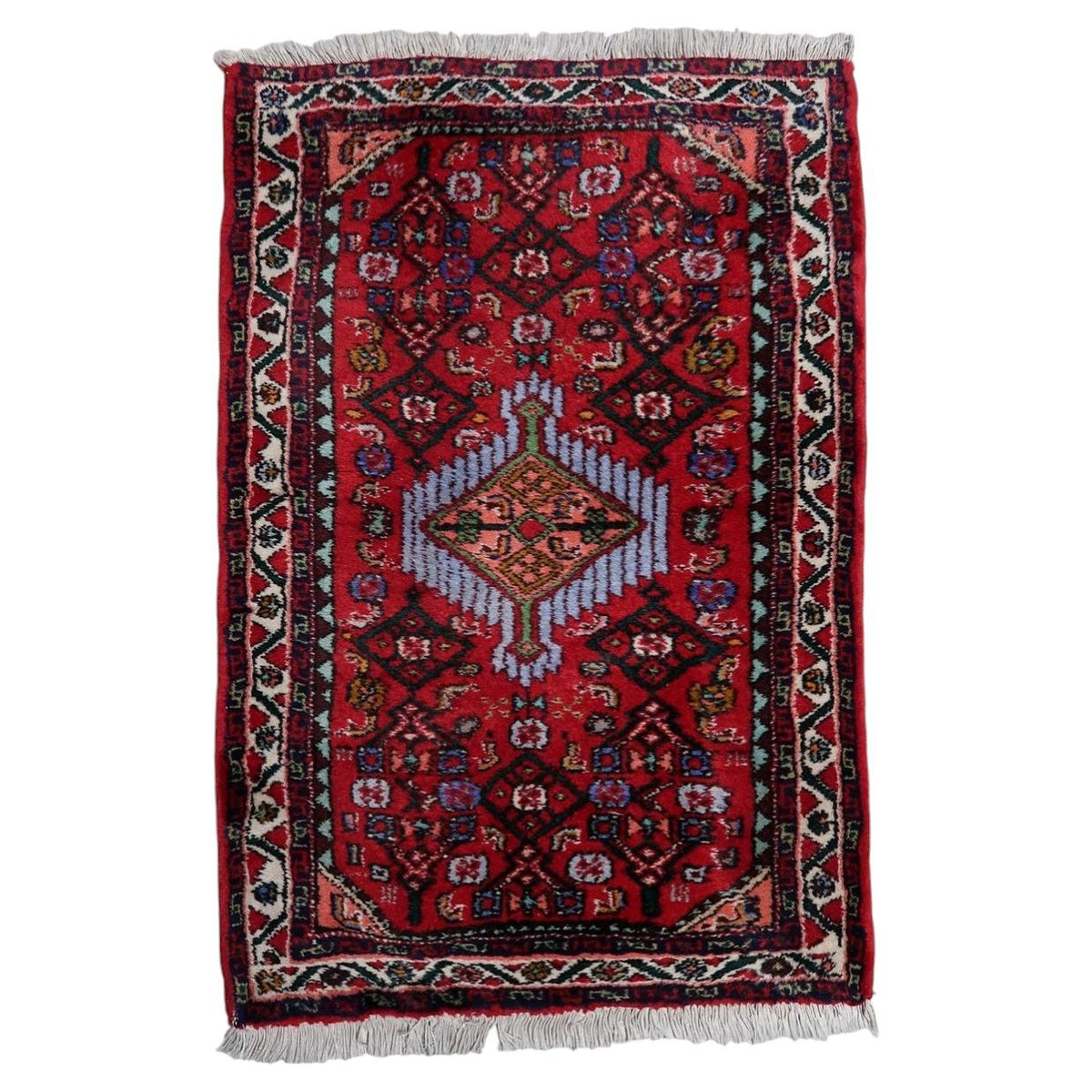 Handmade 1960s wool rug with a striking red central medallion and classic Persian-inspired design
