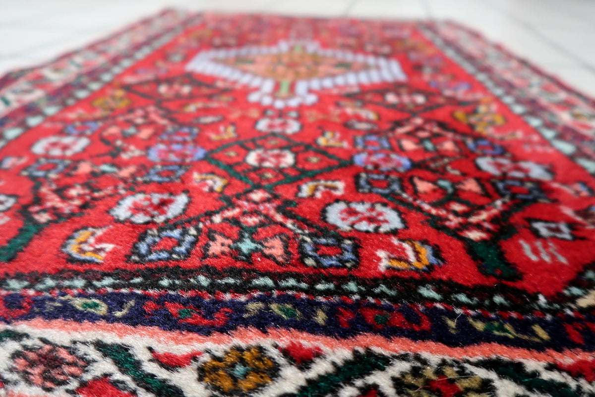 Vintage wool area rug with central medallion motif and traditional Eastern-inspired artistry