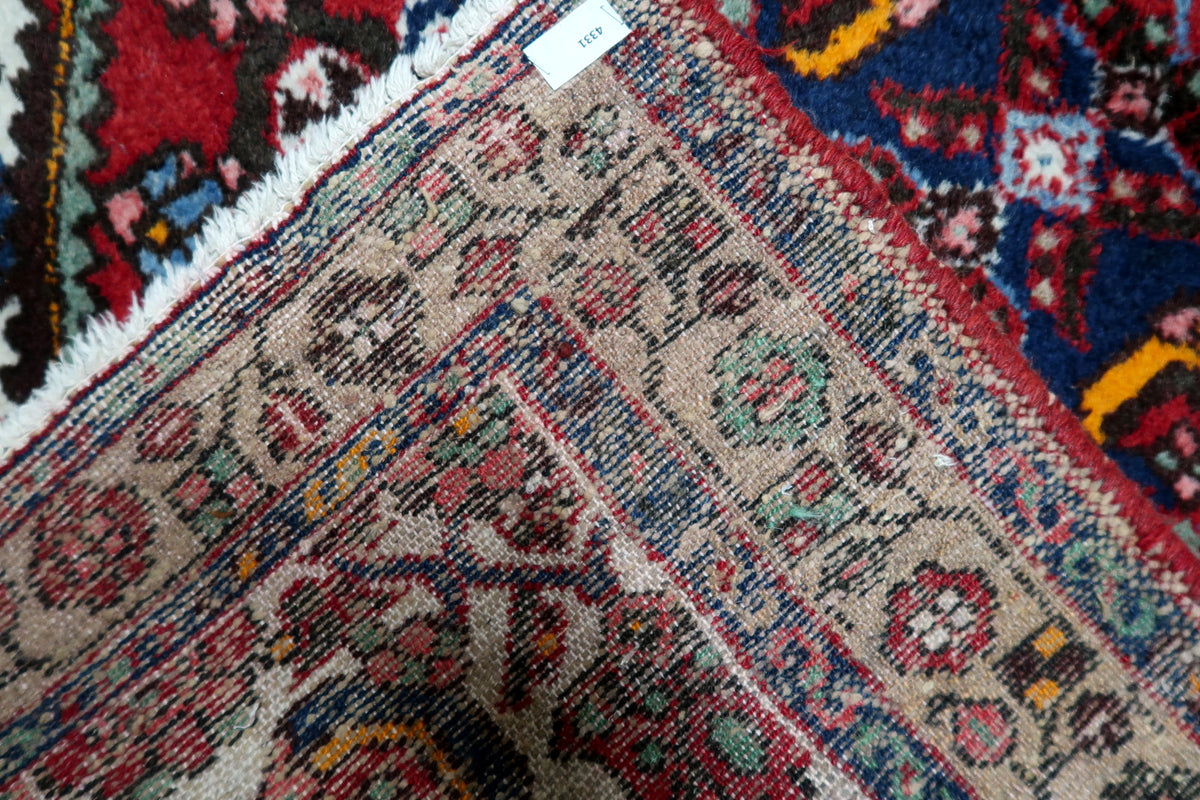Vintage decorative carpet featuring a prominent medallion and detailed floral arabesque patterns