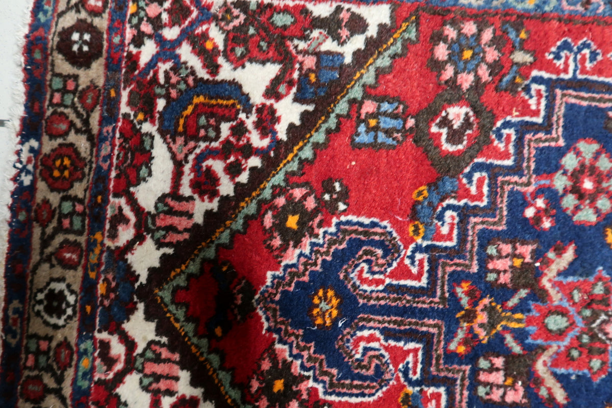 Handcrafted medallion rug with timeless geometric and floral elements in rich contrasting colors