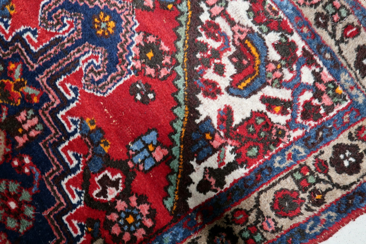 1950s wool area rug displaying an ornate central medallion framed by intricate borders