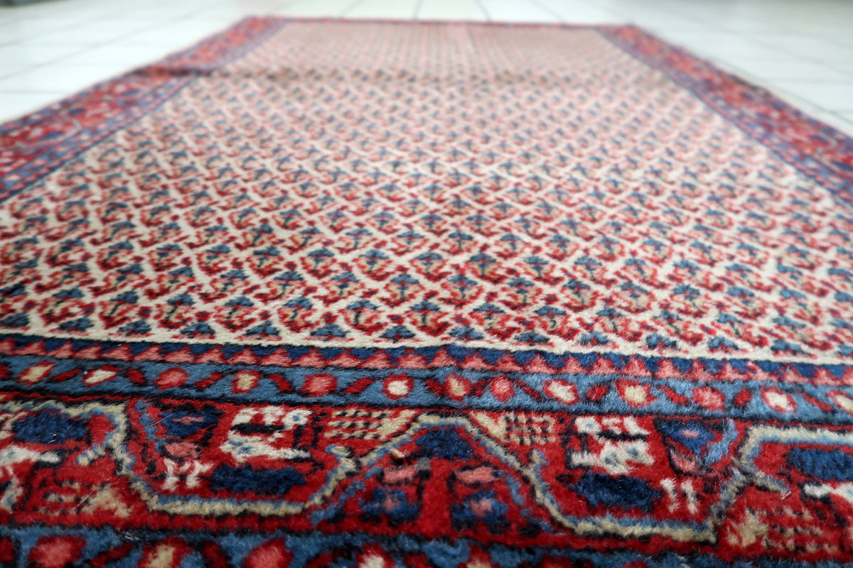 Mid-century 3x5 ft vintage Indian wool rug styled beneath furniture in a modern living room interior.