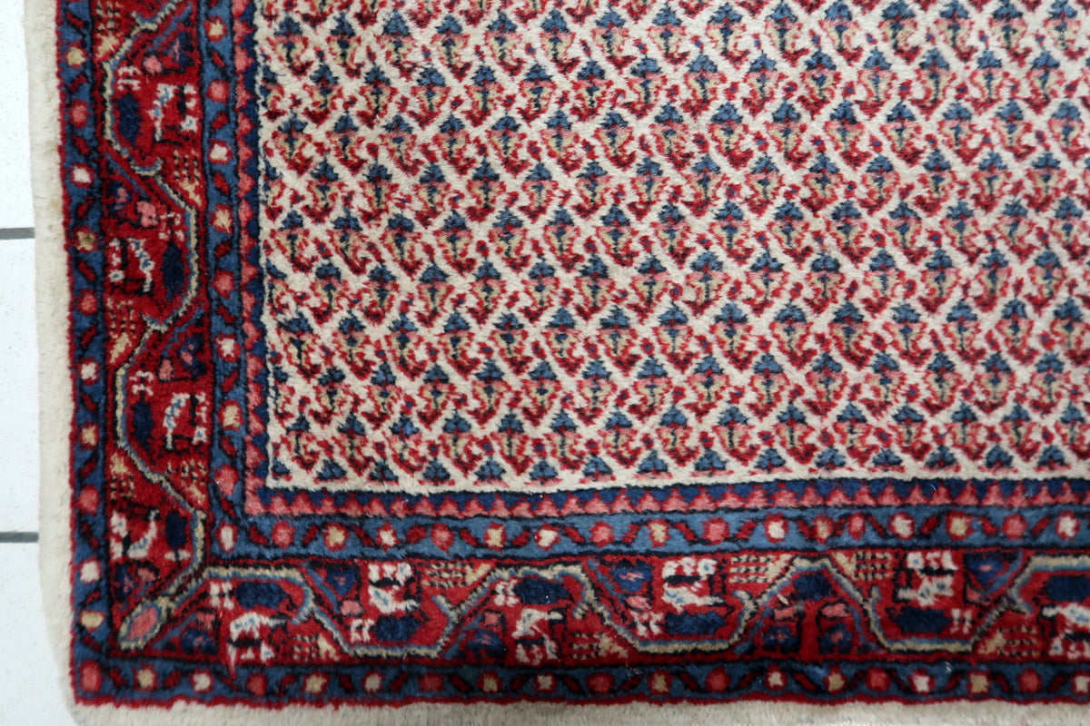 Durable hand-tied cotton warp foundation and authentic woven structure of a 1950s Indian carpet.