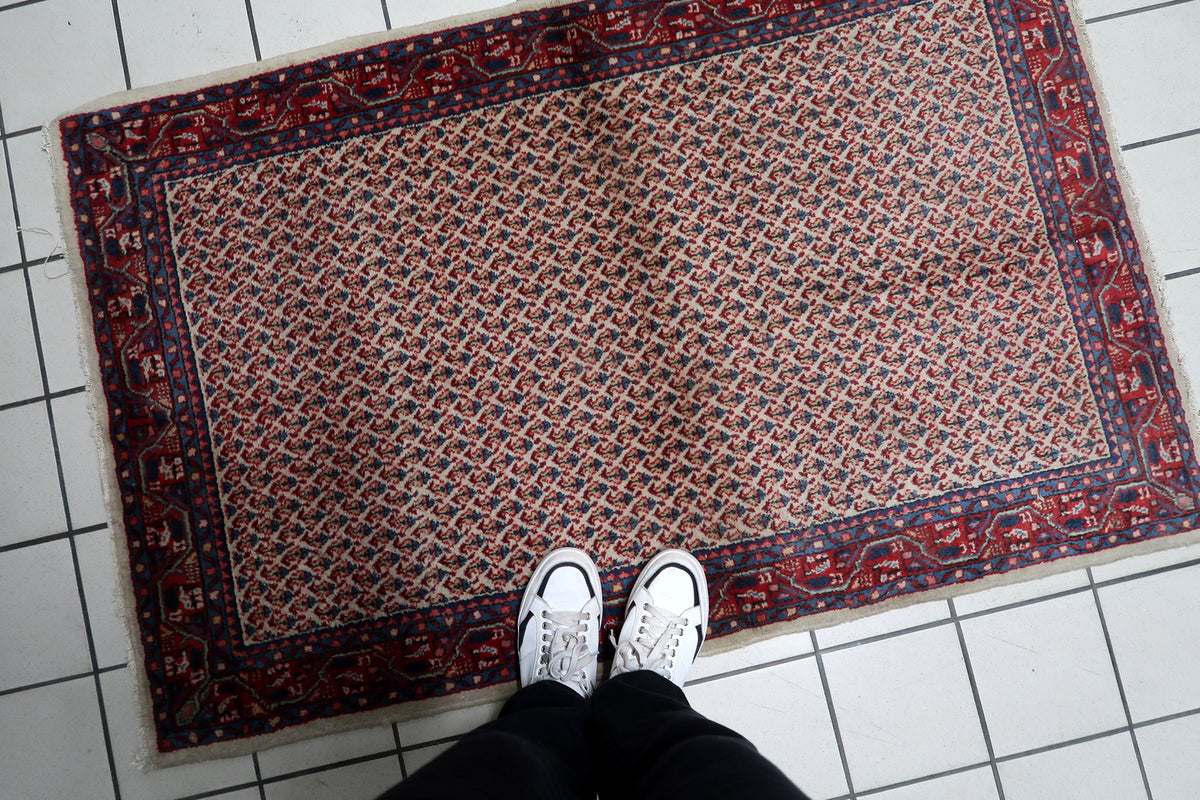 Tight hand-knotted wool weave construction visible on a vintage 3x5 ft Indian area rug.