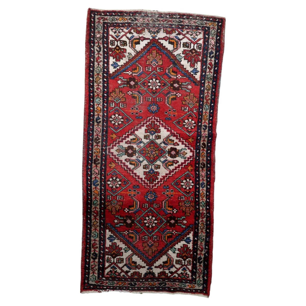 Antique 1920s handmade wool medallion rug in vibrant crimson red and deep indigo blue (Ref: 1C1292).