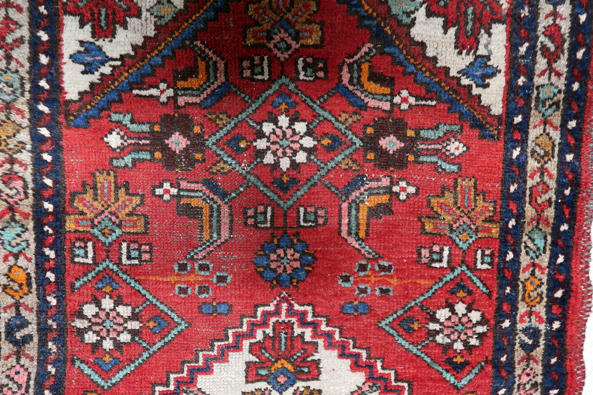 Symmetrical central medallion surrounded by delicate floral palmettes and stylized vine scrolls.