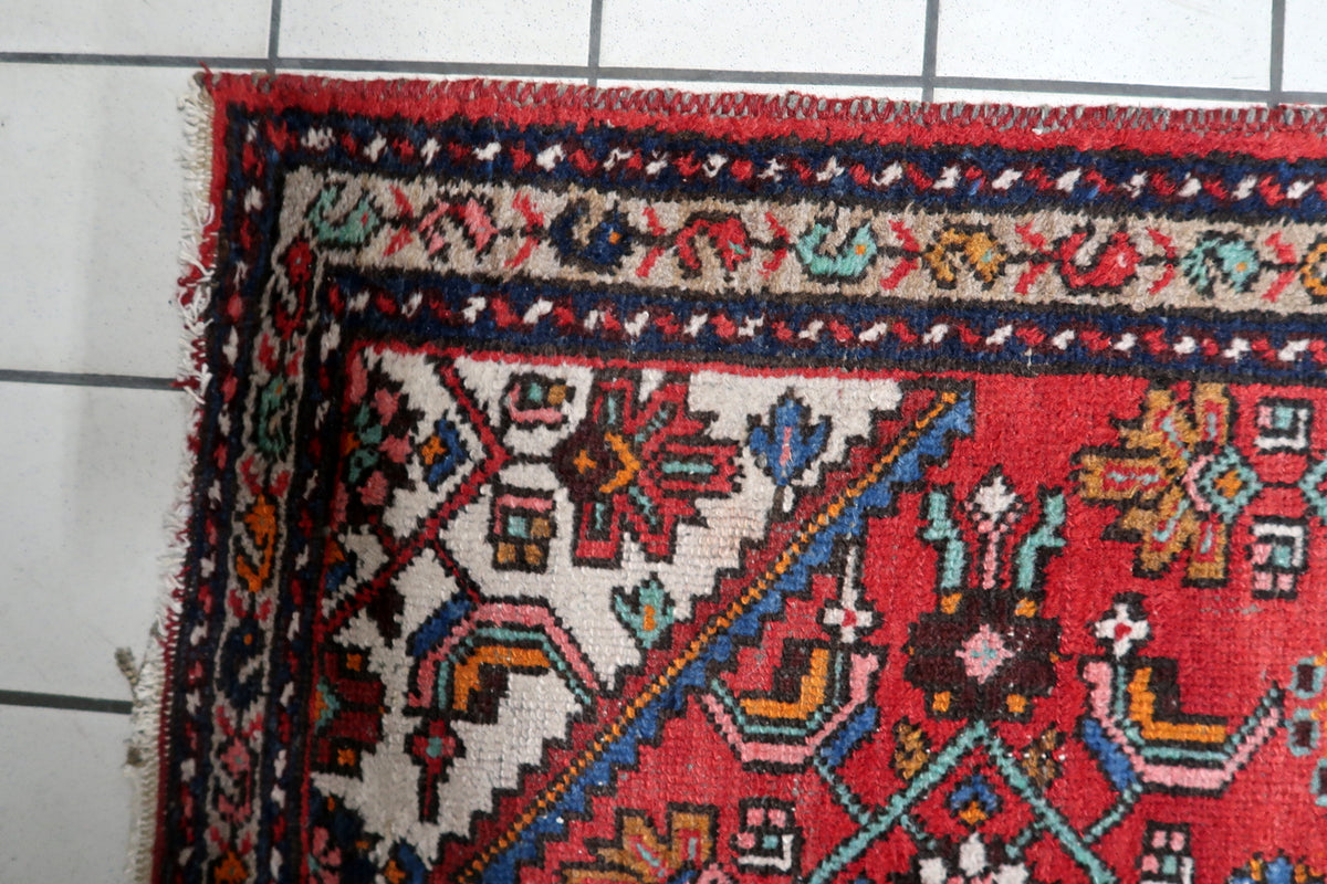 Durable hand-tied cotton warp foundation and tight hand-knotted wool construction of a 1920s Persian rug.