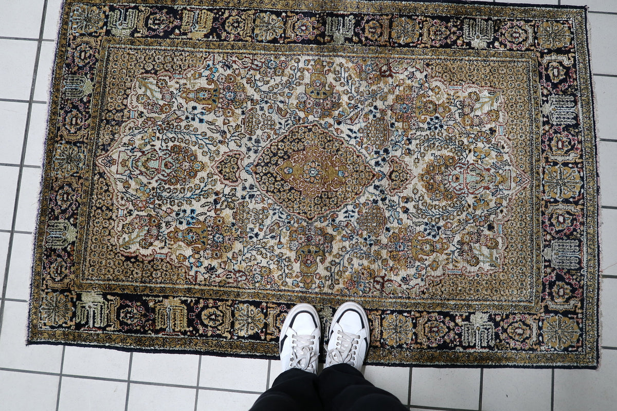 Detailed floral motifs and fine knotwork visible across the front pile of a 3.58 x 5.41 ft Kashmir silk area rug.