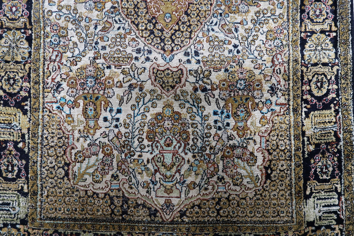 Detailed central floral medallion surrounded by delicate arabesques, palmettes, and fine trailing vine scrolls on silk.