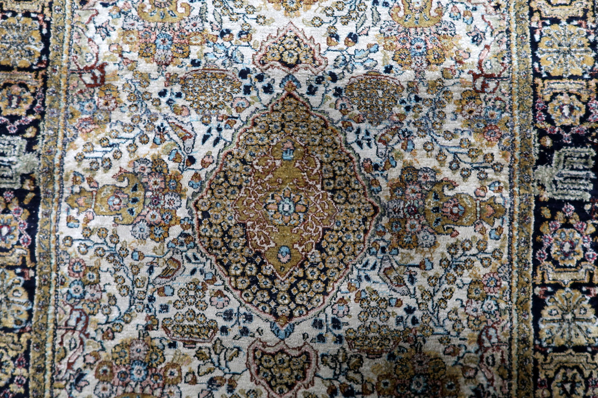 Multi-band framing border with repeating lotus rosettes, intricate guard bands, and fine botanical motifs in Kashmir silk.