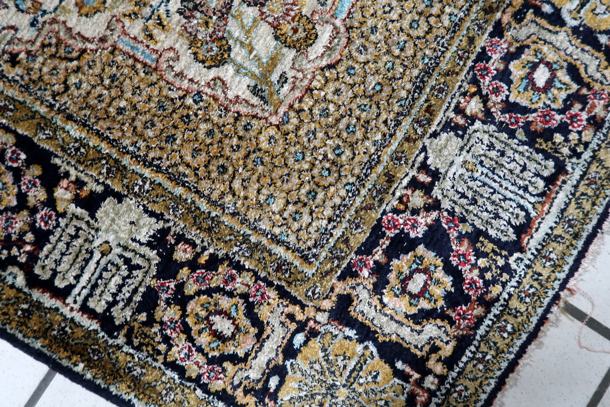 Durable hand-tied silk warp and tight knot construction on a 1950s vintage Kashmir medallion carpet.