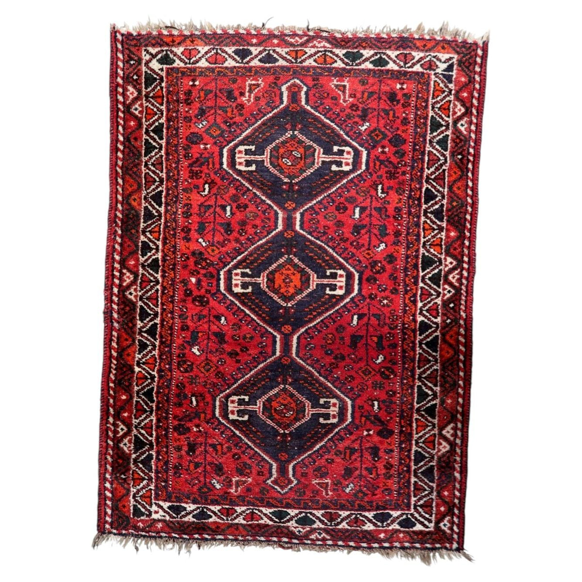 Vintage 1930s handmade wool rug featuring three central medallions and detailed floral geometric motifs (Ref: 1C1294).