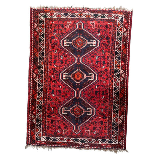 Vintage 1930s handmade wool rug featuring three central medallions and detailed floral geometric motifs (Ref: 1C1294).