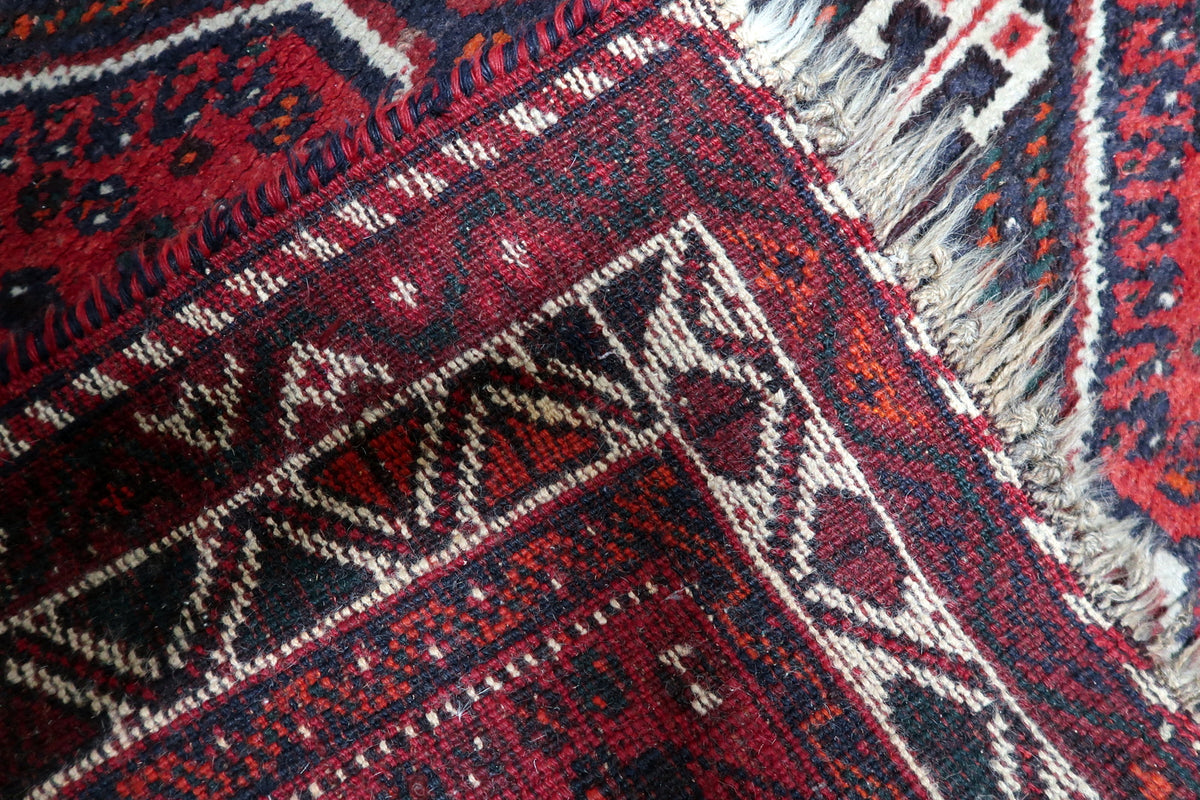 Fine hand-knotted wool pile showcasing natural directional sheen, fiber luster, and vintage character.