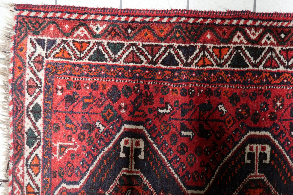 Hand-knotted 1930s oriental area rug displaying a triple medallion composition on a natural wool field.