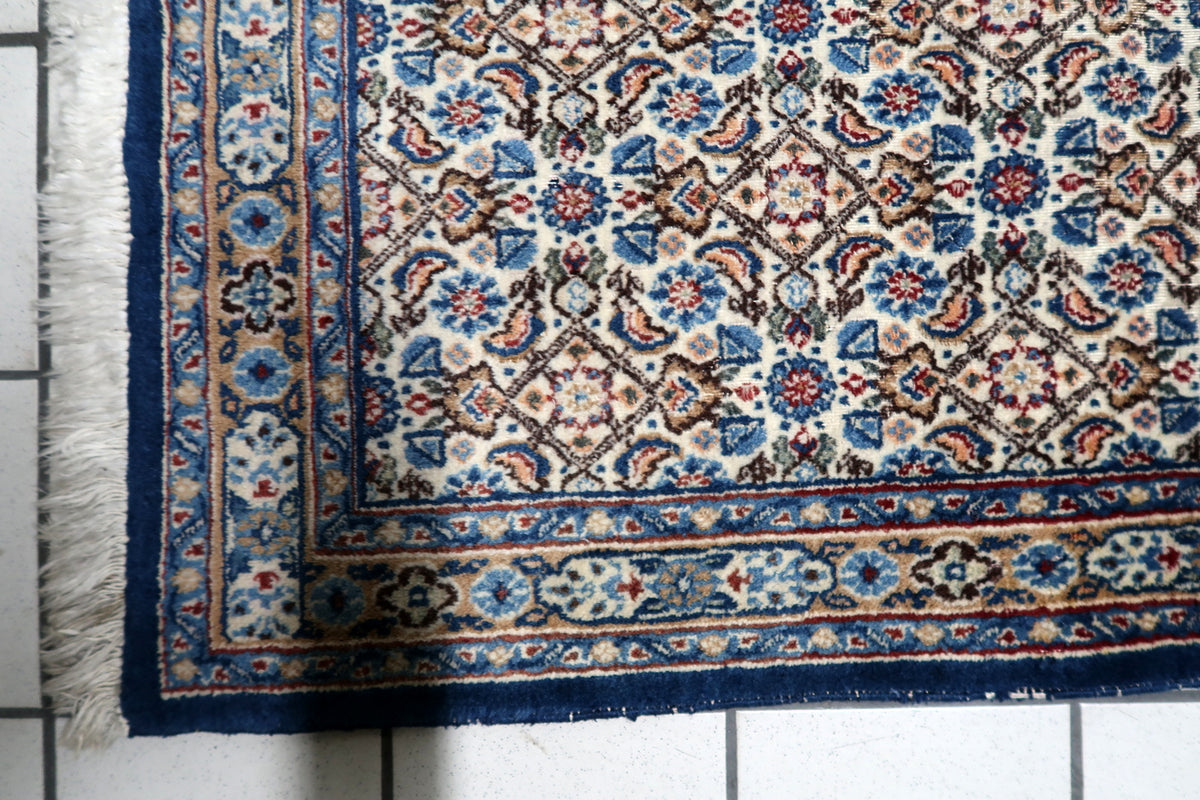 Hand-spun wool pile woven with natural vegetable dyes showing soft abrash color variation and vintage character.