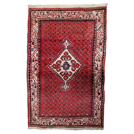 Vintage 1950s handmade Indian wool area rug featuring a central medallion composition on a crimson red field (Ref: 1C1296).