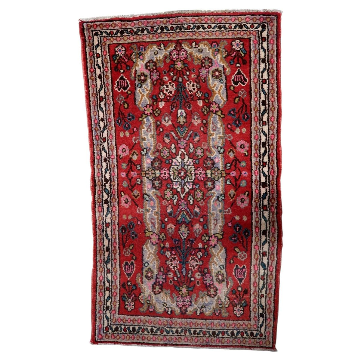 Vintage 1950s handmade Indian wool area rug featuring a central medallion composition on a crimson red field (Ref: 1C1297).