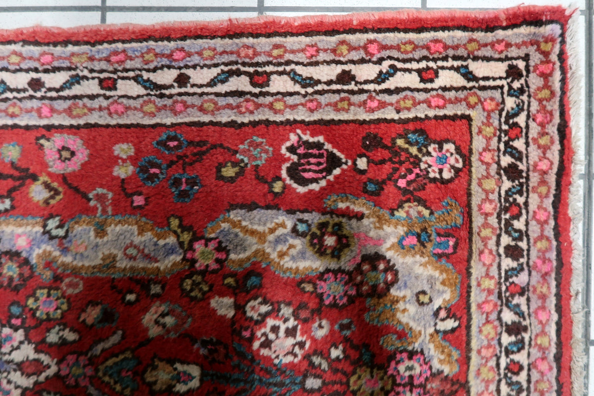 Hand-knotted 1950s oriental accent rug displaying a central star medallion with intricate floral spandrels and traditional borders.