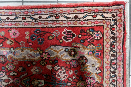 Hand-knotted 1950s oriental accent rug displaying a central star medallion with intricate floral spandrels and traditional borders.