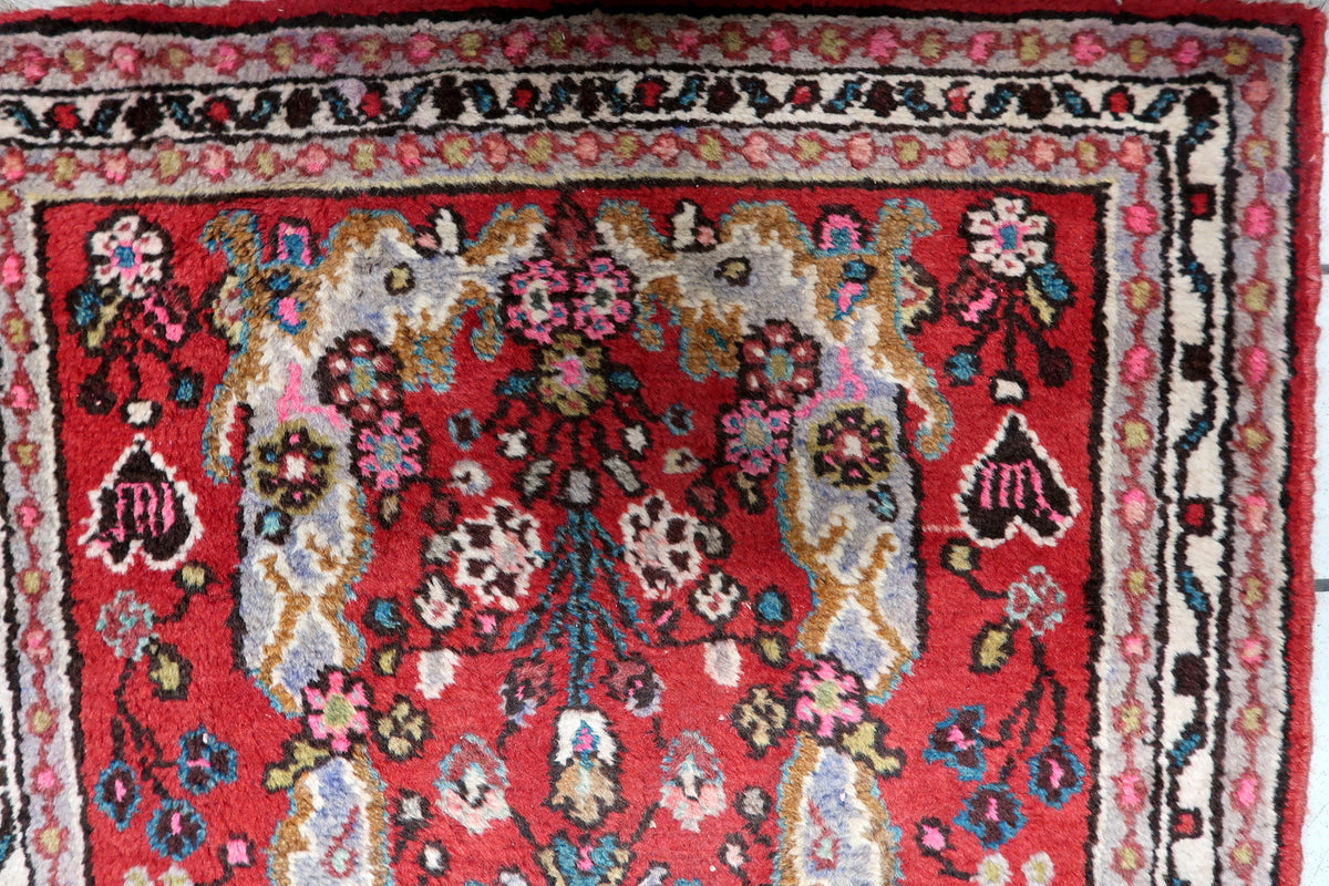 Mid-century vintage Indian wool carpet with rich red, ivory, and deep navy blue color palette and natural fiber sheen.