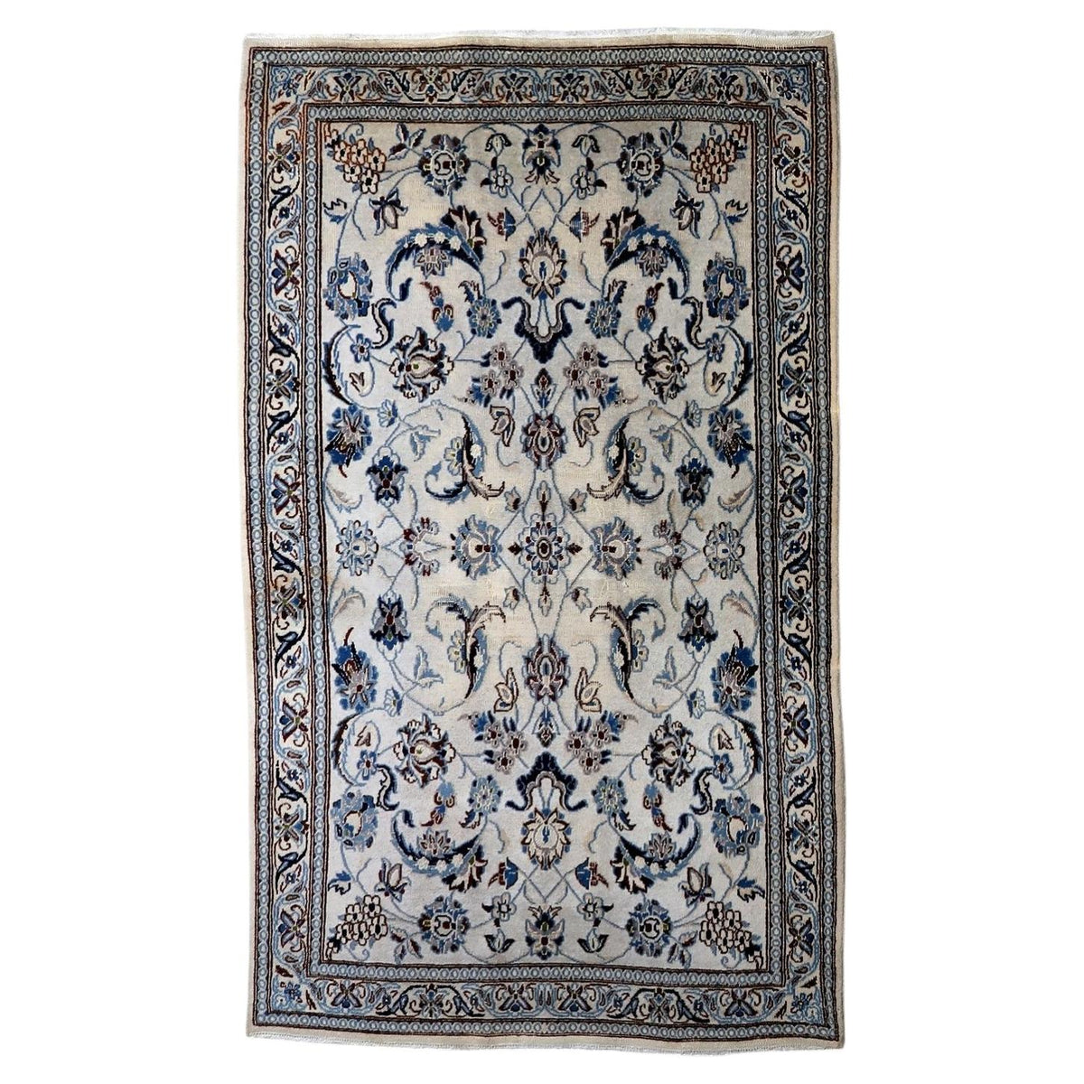 Vintage 1950s handmade wool area rug featuring delicate silk highlights and classic floral motifs in ivory and blue (Ref: 1C1298).

