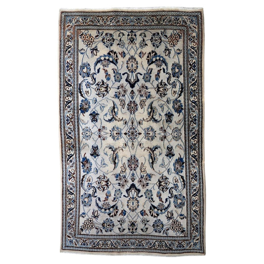Vintage 1950s handmade wool area rug featuring delicate silk highlights and classic floral motifs in ivory and blue (Ref: 1C1298).

