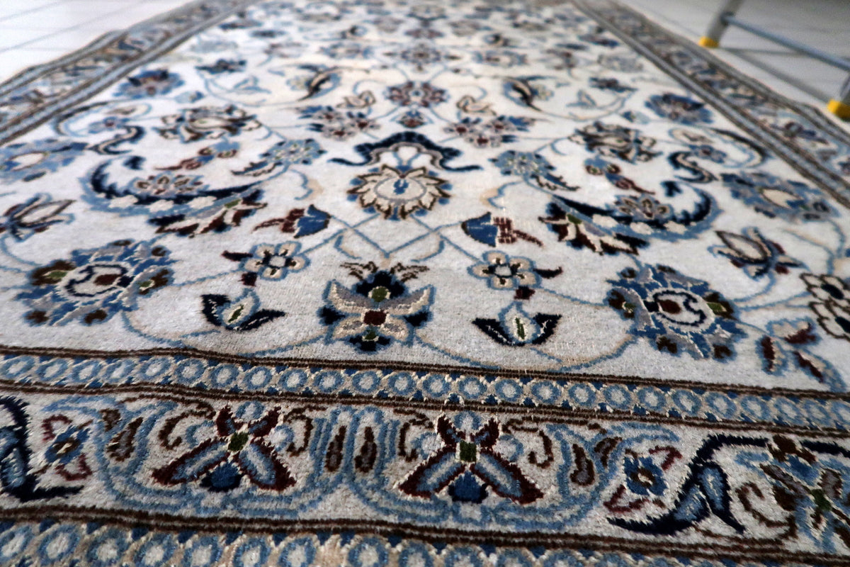 Fine hand-knotted wool and silk pile showcasing natural directional sheen, fiber luster, and soft textured surface.