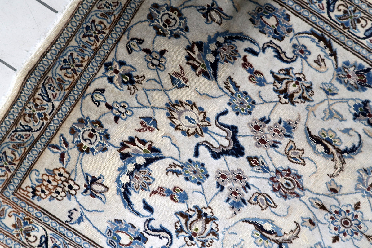 Authentic vintage Persian-style wool and silk blend carpet woven with shimmering highlights and traditional floral scrollwork.