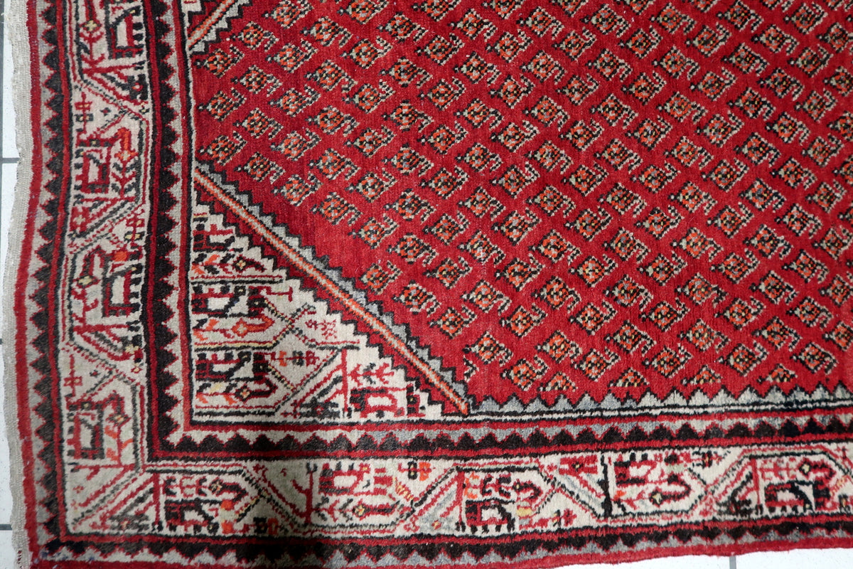 Durable hand-tied cotton warp foundation and tight knot construction on a 1950s vintage boteh pattern scatter rug.