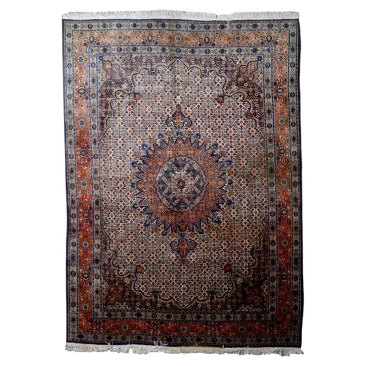 Vintage 1940s handmade wool area rug featuring a central medallion design on a classic ivory and navy blue field (Ref: 1C1300).
