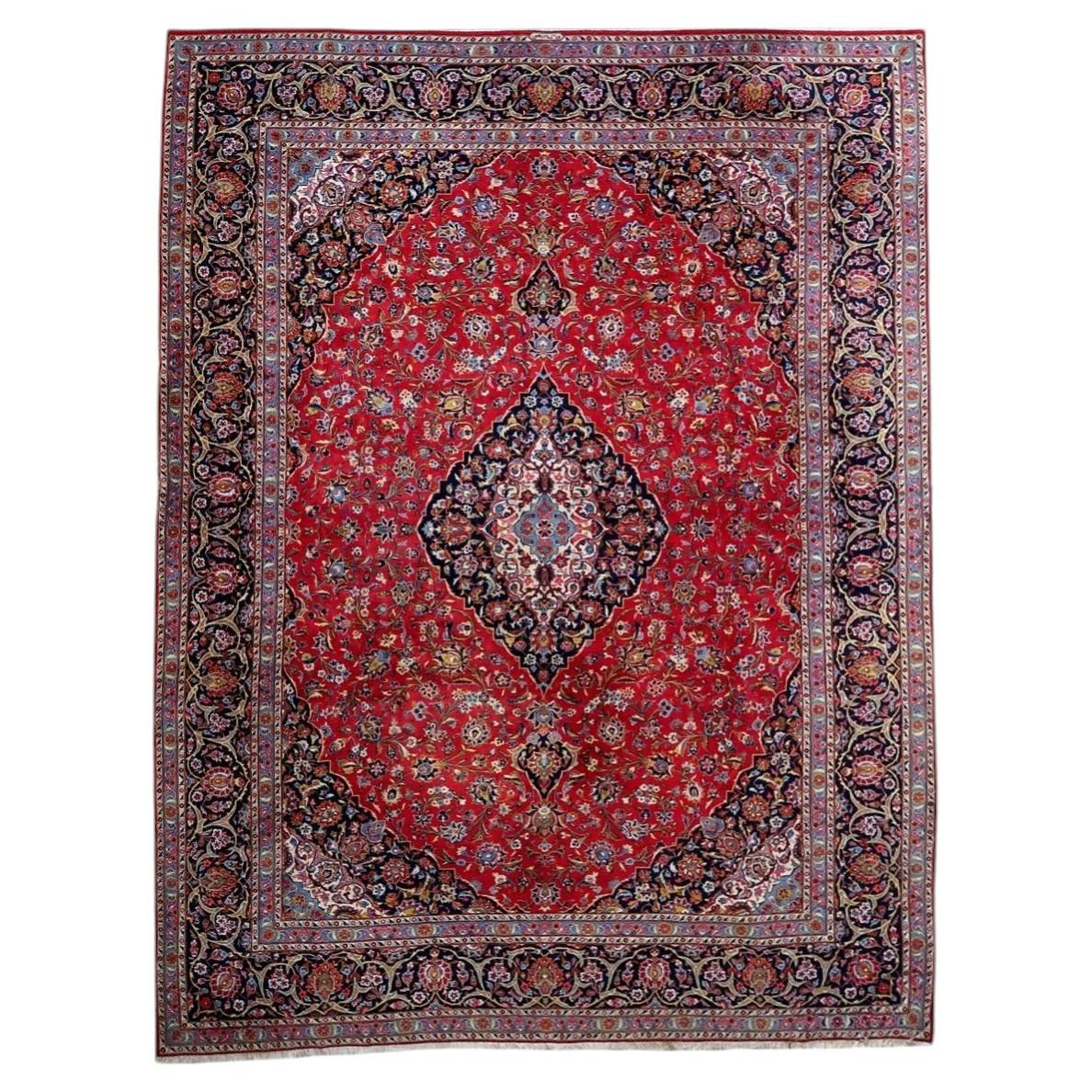 Full view of antique wool rug 1C1302 with red field, navy medallion and layered floral borders