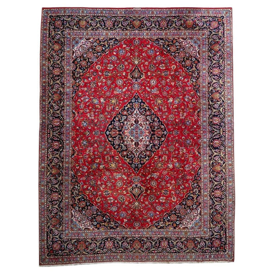 Full view of antique wool rug 1C1302 with red field, navy medallion and layered floral borders