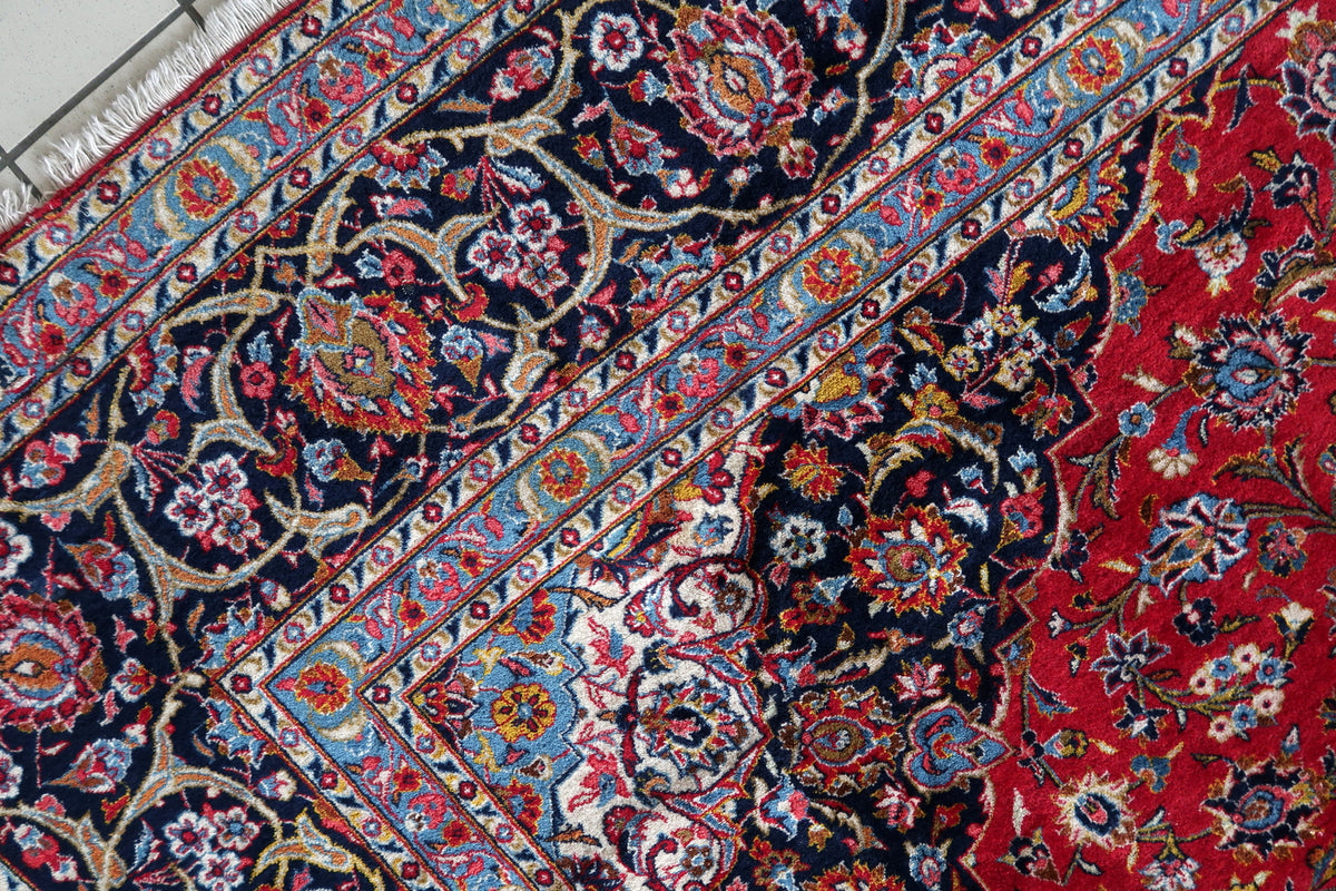 Angled floral corner detail showing navy, sky-blue and ivory border bands