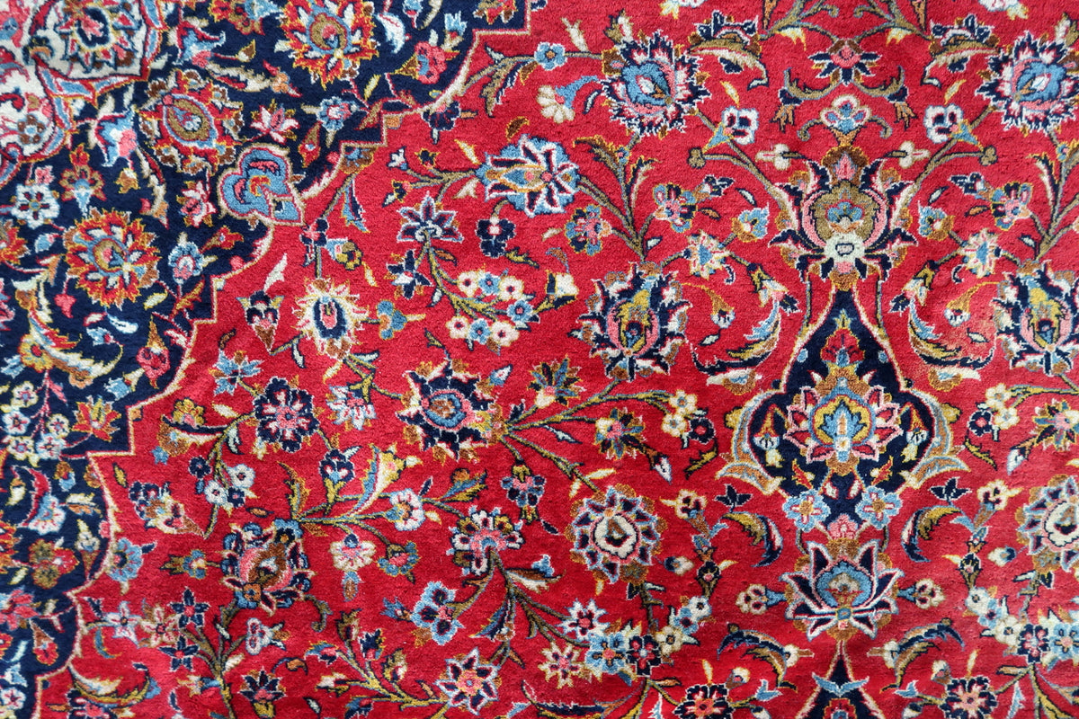 Red wool field with curling leaves, rosettes and olive-green stems