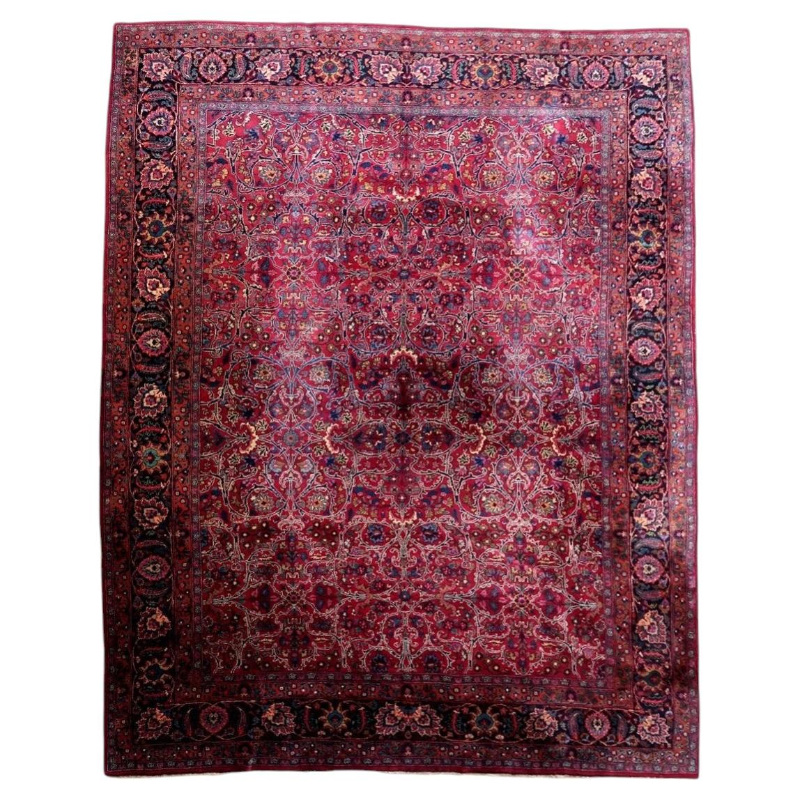 Full view of antique wool rug 1C1303 with red all-over floral field and navy border