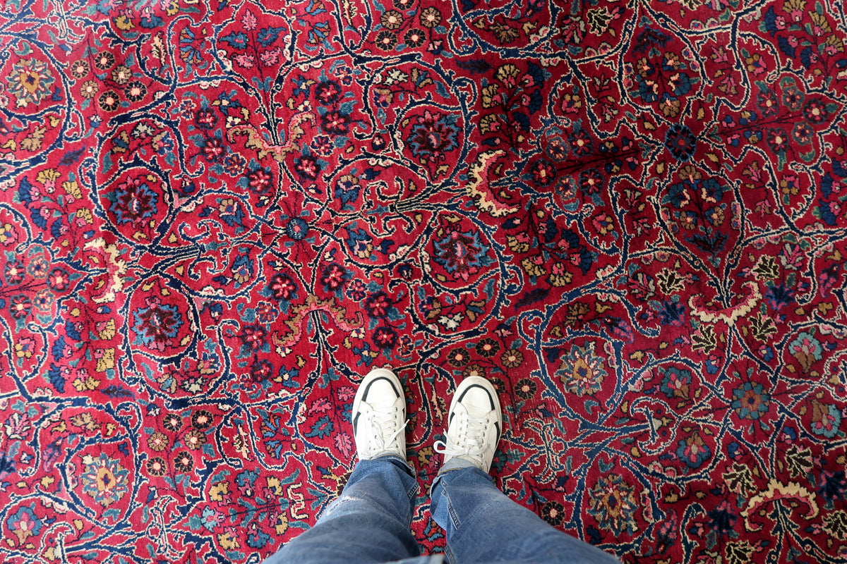 Detailed red wool surface with ivory-edged arabesques and small multicoloured blossoms