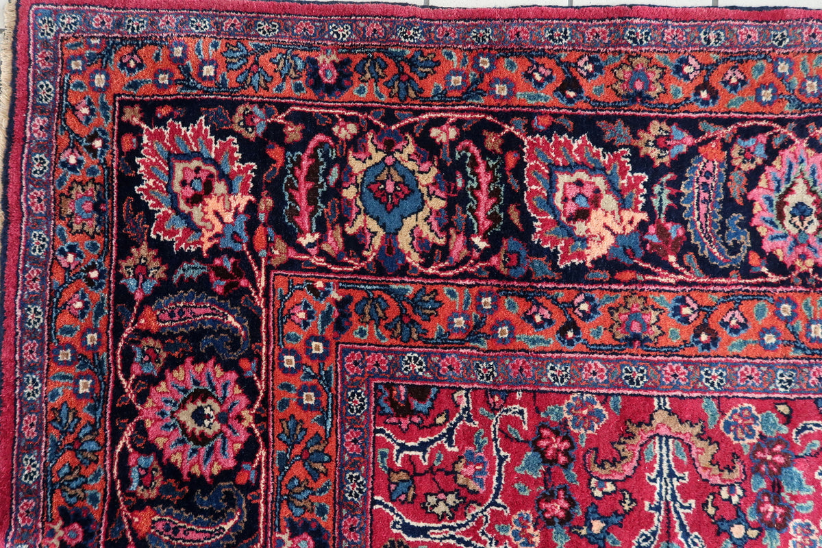 Layered border corner with navy blossoms and narrow rust-red decorative bands