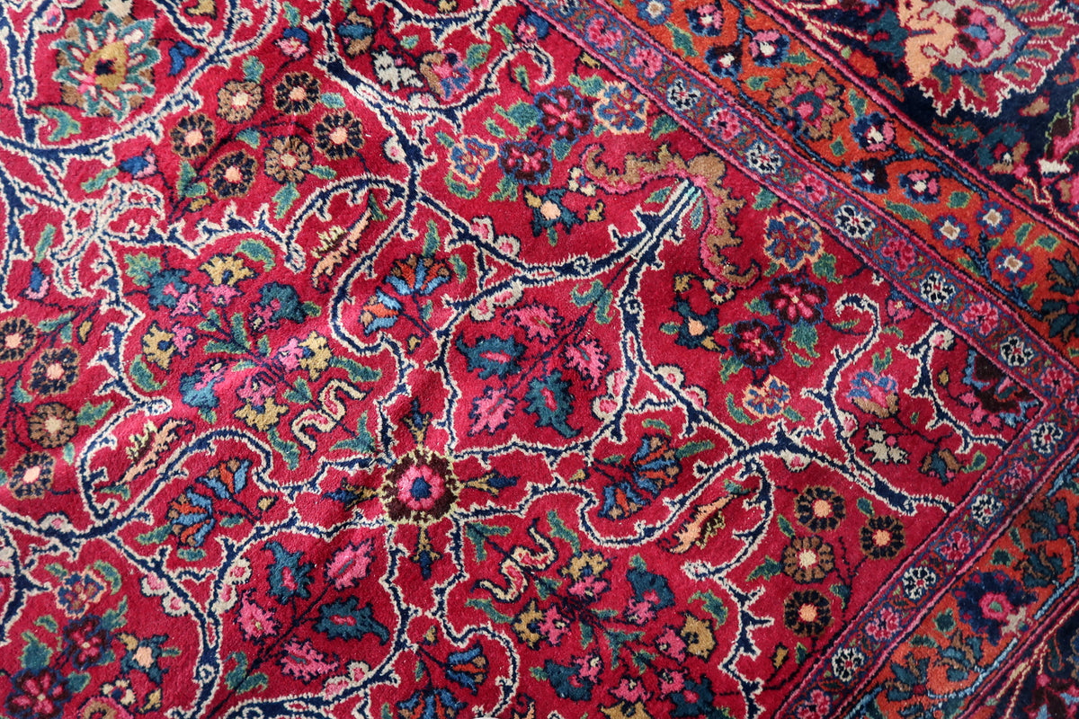 Red floral field beside rust-red guard bands and oversized navy-border blossoms