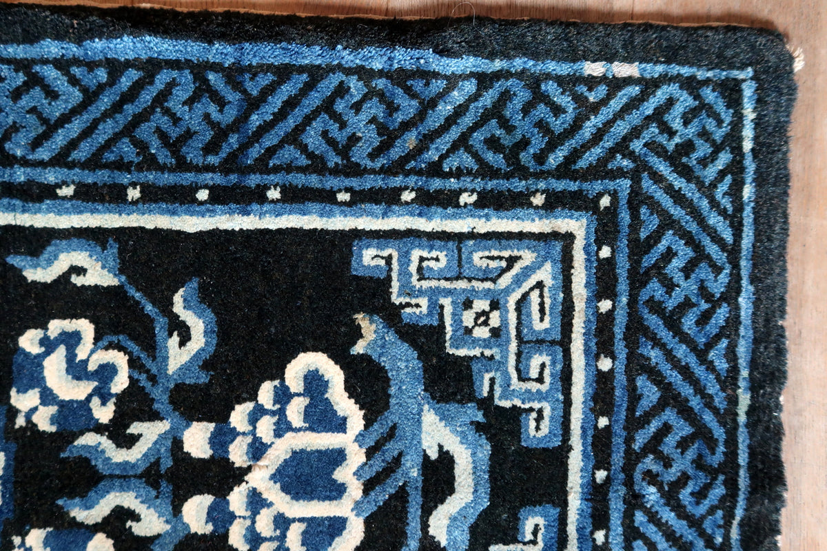 Blue geometric corner ornament, dotted inner band and broad fretwork border