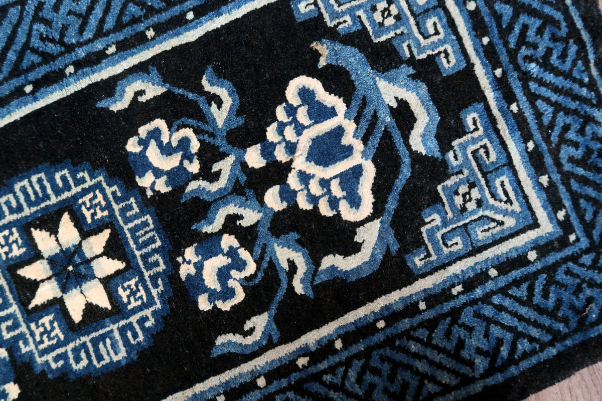 Angled floral field detail showing ivory-edged blossom and curling blue stems