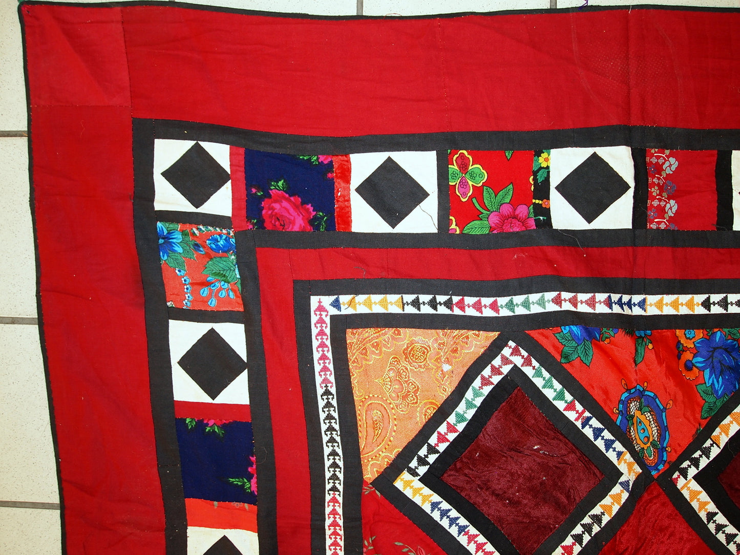 Diamond-shaped velour patches on red cotton base

